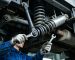Mechanic inspecting Sinotruk Sitrak chassis bolts and shock absorbers (genuine parts)